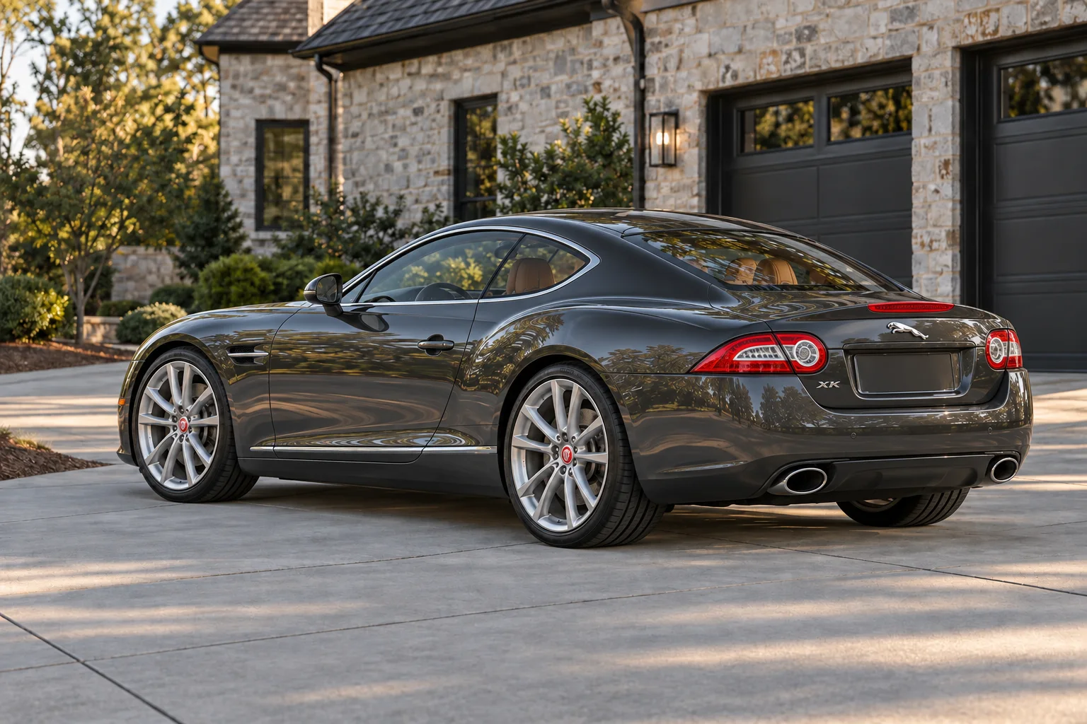 Rear three-quarter view of the graphite grand touring coupe in the same driveway